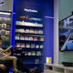 A sales person assisting a young customer at a game store in Beijing.